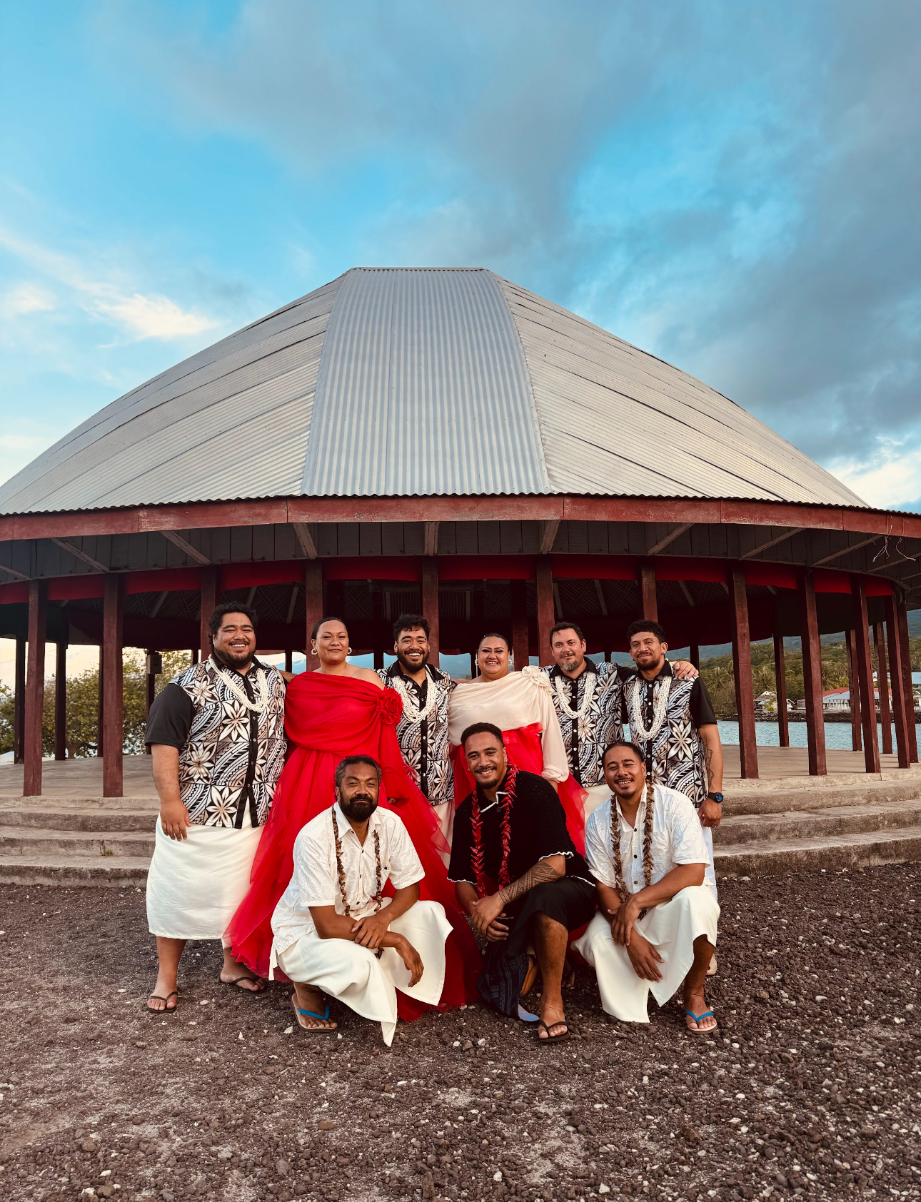 The nine Island Vibes musicians together outside a fale in Samoa